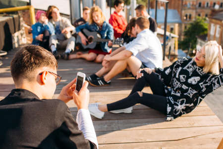 Mobile photo on a rooftop. Young girl posing. Friends hangout. Trip memoriesの写真素材