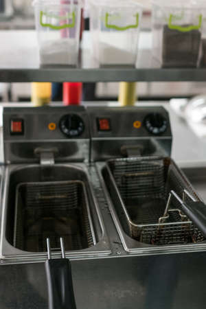 Professional restaurant kitchen facility. A chip fryer for cooking delicious fast food french friesの写真素材