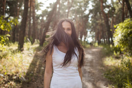 Pretty sunny stranger woman forest happiness concept. Secrets in her eyes. Unity with nature.
