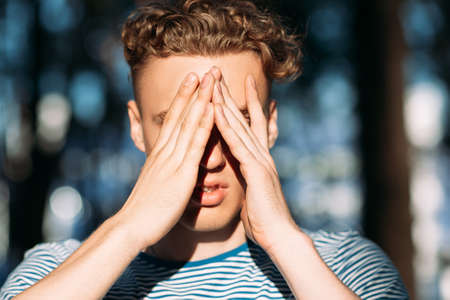 Upset handsome hiker man nature concept. Traveler lifestyle. Alone with problems.の写真素材