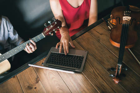 online music school. young people learn how to play instruments through the internet. limitless possibilities for education thanks to modern technologies conceptの写真素材