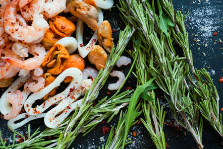 Seafood mix on dark background. Asian cuisine. Healthy eating. Diet food concept