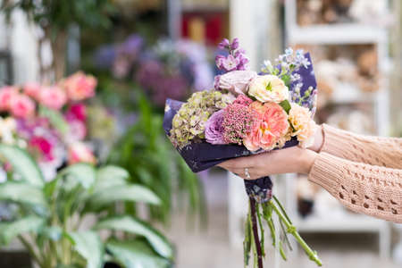 Tender bouquet of various flowers as a Mothers day gift. Beautiful floral composition of roses, lilacs and hydrangea as a reward to ones Momの写真素材