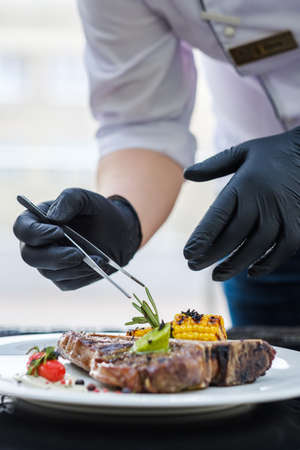 Food perfectionist. Styling meal with precision concentration and excellence. Restaurant servingの写真素材
