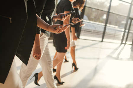 women unity partnership business phone concept. collective solution of business issues by mobile phoneの写真素材