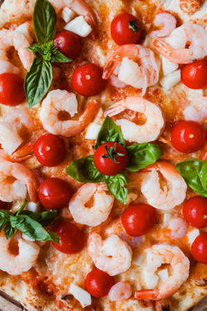 Seafood pizza with shrimps and tomatoes background. Tasty italian food conceptの写真素材