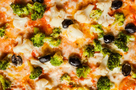 Vegan cauliflower broccoli and olives pizza background. Diet food contains vegetable proteins for healthy eating conceptの写真素材
