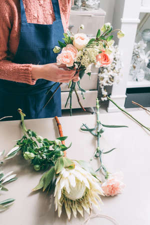 Floristry courses. Learn to master the art of ikebana. Florist shares her skills showing how to arrange flowers in a perfect beautiful bouquetの写真素材