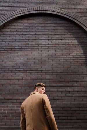 Back view of lonely emotional young man. Depressed frustrated expression. Melancholy sadness emotion. Copy space conceptの写真素材