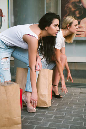 Women shopping sale discount fighting clothing concept. Low start. Shopaholic lifestyle. Pursuit of fashion tendenciesの写真素材