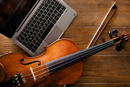 new music album upload. laptop internet technology. classical instrument in modern society conceptの写真素材