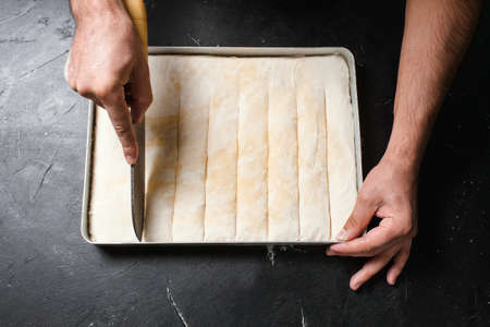 Food pastry. Baker works with dough. Recipe and cooking conceptの写真素材
