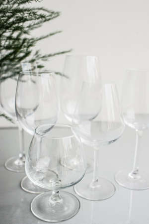 Crystal clear wine and cognac or brandy glasses on white background. Festive celebration or banquet party conceptの写真素材