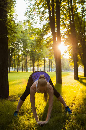 sport training stretching outdoor healthcare concept. exercise to develop flexibility. active lifestyle.の写真素材