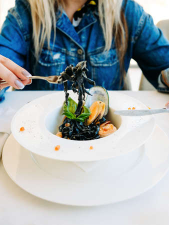 tasting restaurant seafood black pasta concept. traditional kitchen. national cuisine. delicious...