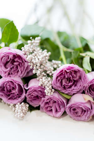 Pink roses and silver decor. Pretty birthday flower arrangement gift. Simple composition to surprise your loved oneの写真素材
