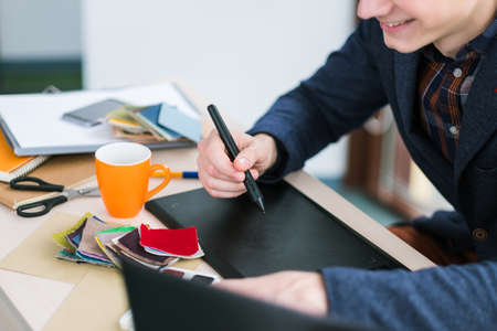 fashion designer sketching on graphic tablet. Creation of new clothes. Unique ideas, unusual...