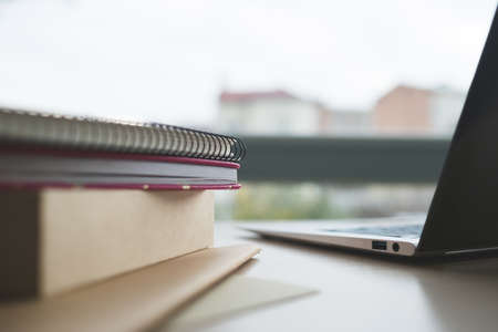 Modern education - get a degree on the web. Learning your profession at online university. Books, notepads and laptop on the table.の写真素材