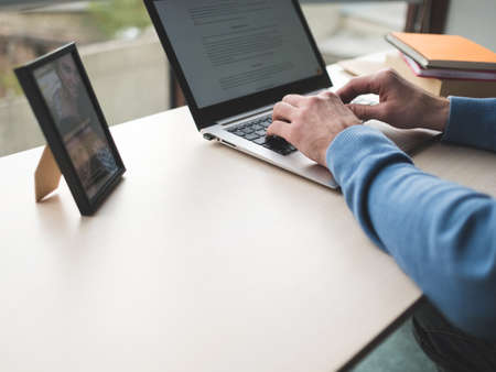 Office work. Man typing on the laptop in office. White collar daily business routine