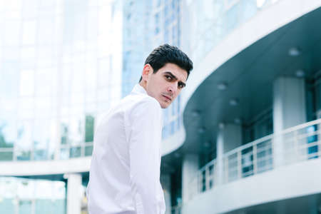 serious casual business man frowning. stern confident look. outdoor urban city backgroundの写真素材