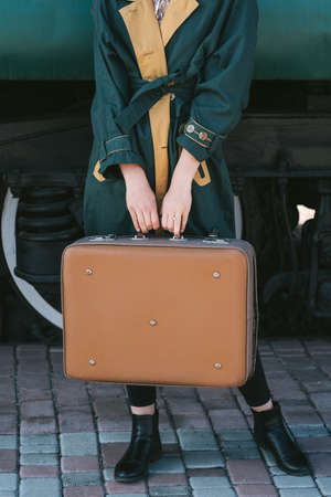 travel trip tourism leisure. traveler lifestyle. train station vacation destination. woman holding a suitcaseの写真素材