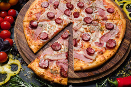 traditional italian food cuisine. delicious pizza slice ham prosciutto and pepperoniの写真素材