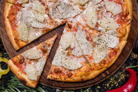 traditional italian food cuisine. delicious pizza slice chicken pineappleの写真素材