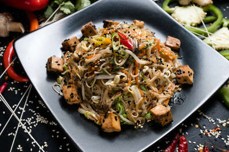 noodle fried tofu and vegetable dish recipe. meal food ingredients and cooking process. vietnamese cuisineの写真素材