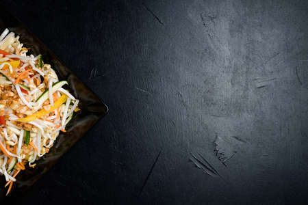 asian cuisine food. wheat sprouts and vegetable salad on dark background. balanced healthy nutrition. copy space conceptの写真素材