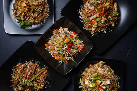 asian restaurant family dinner. menu meal assortment. meat and veggie salads for balanced nutrition and healthy diet.の写真素材