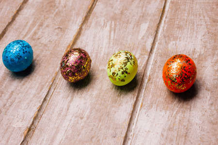 easter eggs on wooden background. colorful glitter design. festive decoration