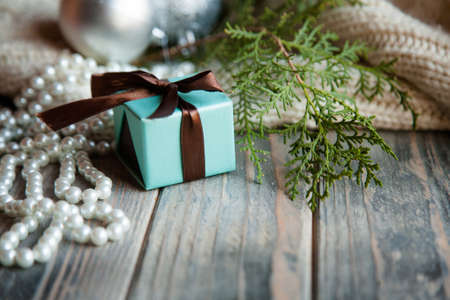 christmas gift on festive holiday background. present blue box and tied with chocolate brown ribbon.の写真素材