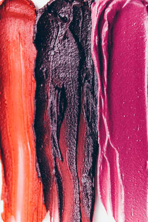Makeup background. Beauty art fashion. Smeared textured lipstick samples.
