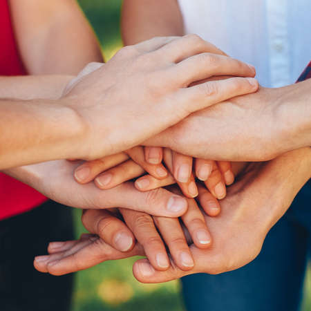 True friendship. Togetherness teamwork. Male female group hand stack.の写真素材