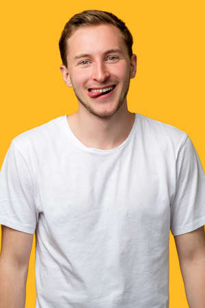 Funny man portrait. Carefree lifestyle. Enthusiastic guy sticking tongue out smiling isolated on...
