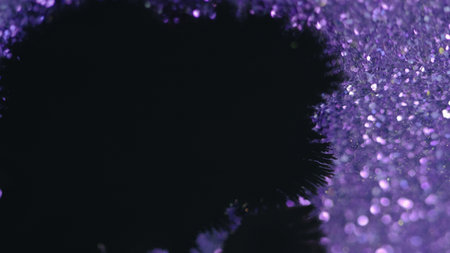 Ink drop paint splatter black purple bokeh lightの写真素材