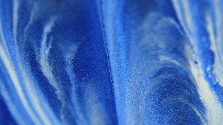 Glitter paint flow shimmering texture blue whiteの写真素材