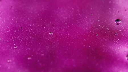 Shimmering gel oil bubbles neon pink glitter spillの写真素材