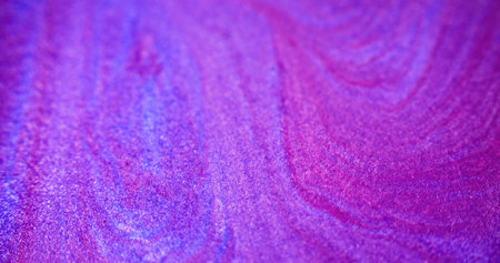 Glitter fluid mix. Wet shimmer texture. Blur purple pink color shiny sand grain particles acrylic paint mix ink pigment liquid spill abstract art background.の写真素材