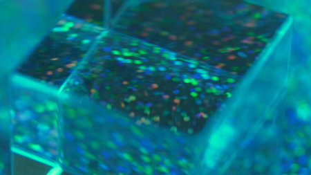 Bokeh light. Glass cube. Defocused transparent blue green orange color circles crystal prism...