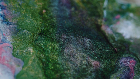 Glitter fluid spill. Paint flow. Defocused green blue pink color sparkling metallic ink mix wave bokeh light texture abstract art background.の写真素材