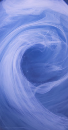 Water dye. Color smoke. Ink flow. Blur white translucent steam paint liquid mix swirl mist texture floating gas on sky blue abstract art background.の写真素材