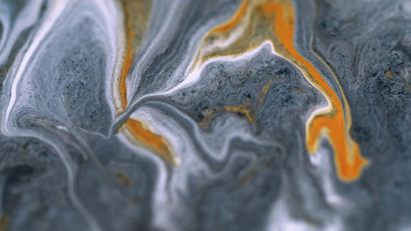 Sparkling ink wave. Marble texture. Defocused white gray orange color golden metallic glitter particles paint swirl acrylic fluid spill abstract art background.の写真素材