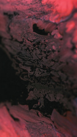 Shiny ink spill. Paint liquid. Blur black red color sparkling glitter sand particles acrylic fluid water pigment mix emulsion flow abstract art background.の写真素材
