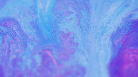 Acrylic paint spill. Sparkling fluid flow. Defocused purple blue pink color shiny glitter particles dye emulsion ink liquid pigment blend abstract art background.の写真素材