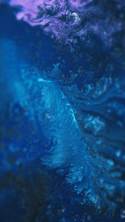 Ink spill. Sparkling fluid texture. Defocused blue pink cyan color shimmering glitter particles acrylic dye emulsion paint liquid flow abstract art background.の写真素材