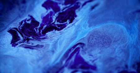 Fluid splash. Paint flow. Defocused cold blue color glowing acrylic ink water emulsion spill wave creative abstract art background.の写真素材