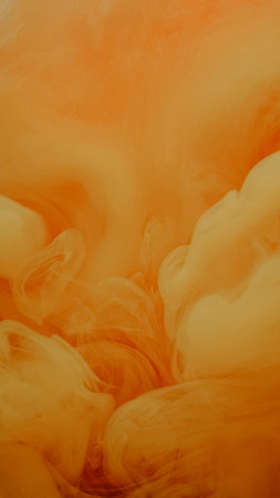 Smoke wave. Paint water drop. Defocused yellow orange color fume splash flow on sparkling glitter...