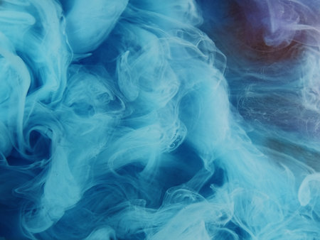 Twisted steam. Colorful smoke cloud. Glitter blue purple mist ink on sparkling gold background creative hypnotic abstract shimmering art.の写真素材