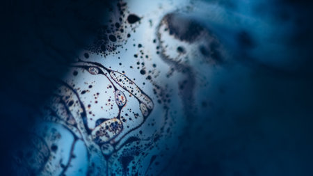 Blur foam blend. Bubble liquid. Defocused blue orange color fizzy texture fluid mix wave on dark black light flare abstract art background.の写真素材